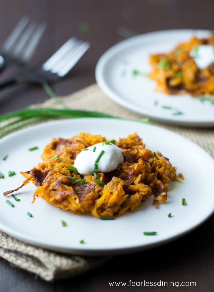 Curried Sweet Potato Hash Brown Waffles on plates with forks in the background