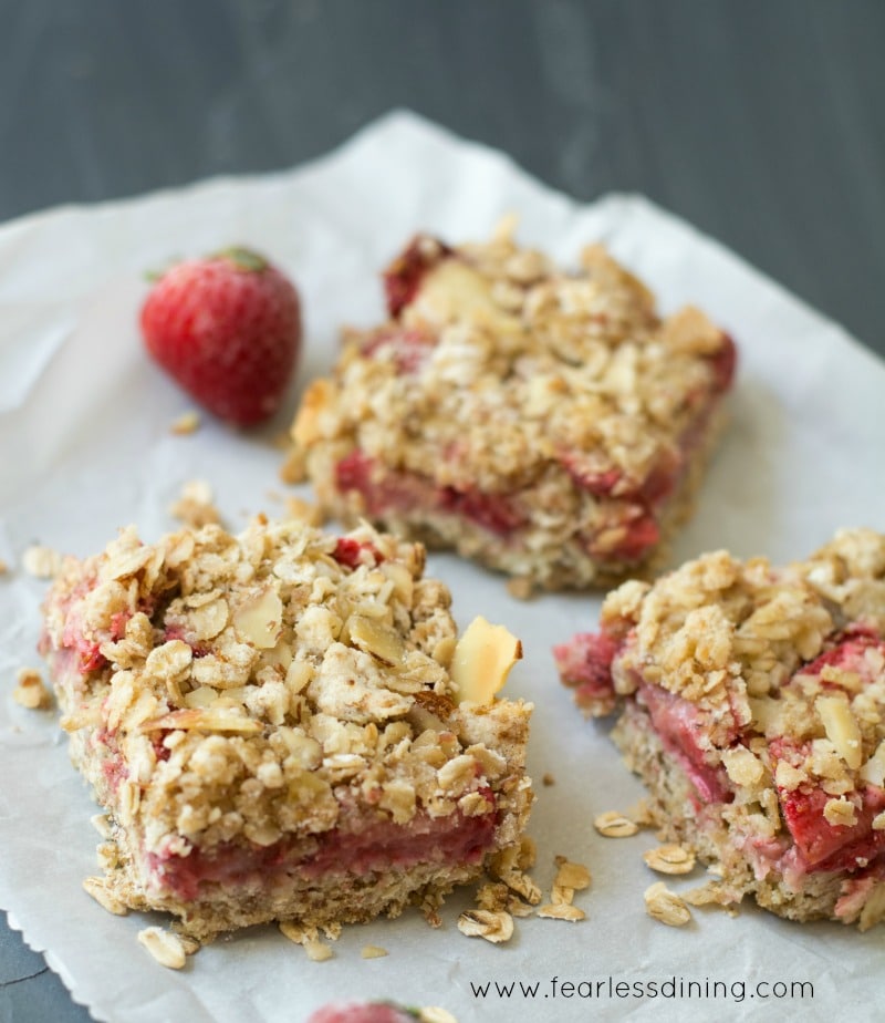 Gluten Free Fresh Strawberry Oatmeal Bars on a piece of parchment paper.