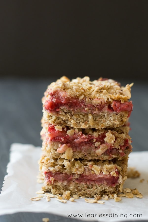 Three Gluten Free Fresh Strawberry Oatmeal Bars stacked on top of each other.