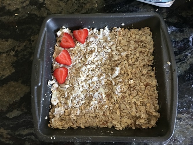 Layering Strawberries on top of the oatmeal