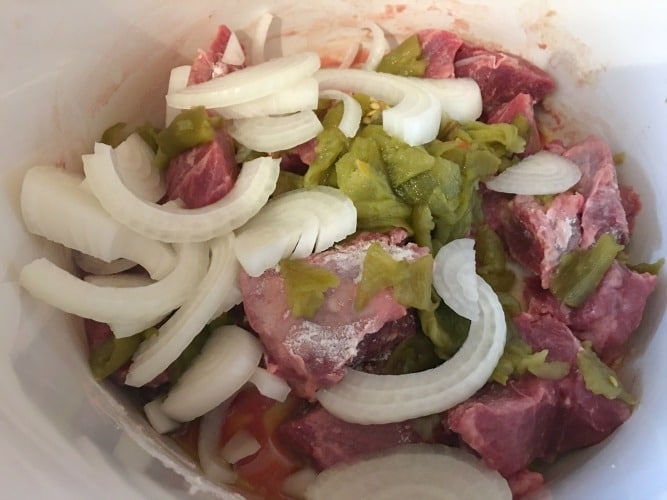 Lamb, onion, and hatch chiles in the crockpot.