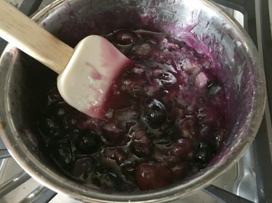 The black grape pie filling in a pan.