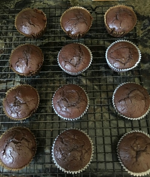 Chocolate cupcakes on a cooling rack.