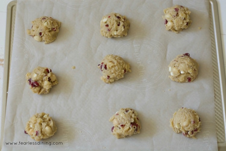 Cranberry cookie dough balls on a baking sheet ready to bake