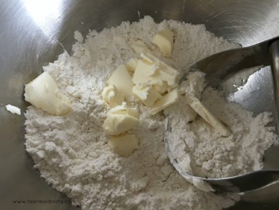 Cutting butter into the flour to make the crust.