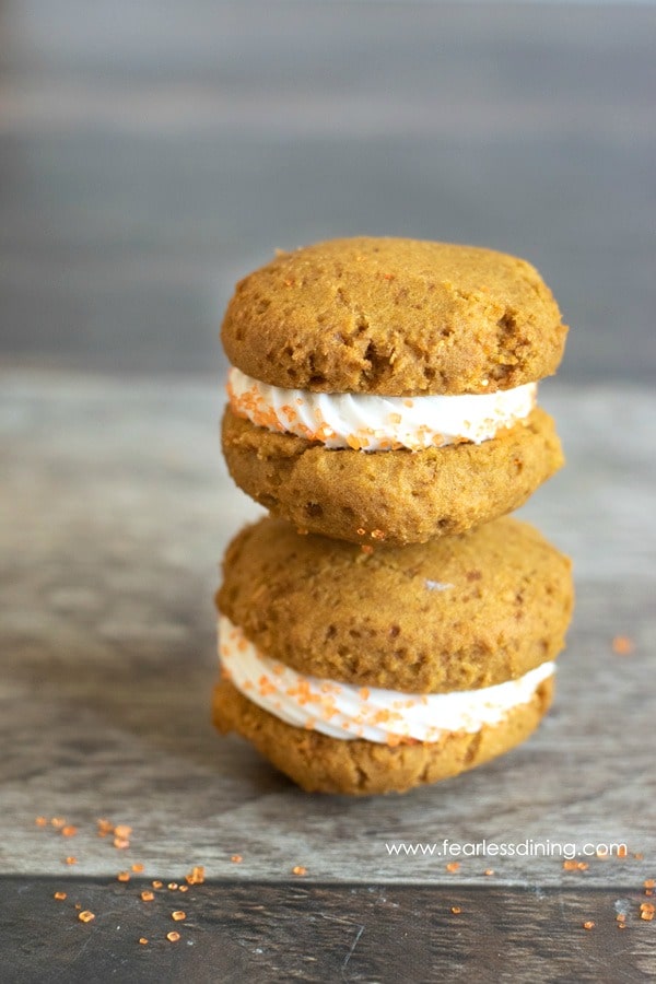 Two gluten free pumpkin whoopie pies stacked on top of each other.