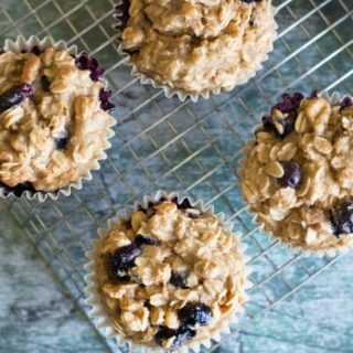 Gluten free blueberry oatmeal muffins on a cooling rack.