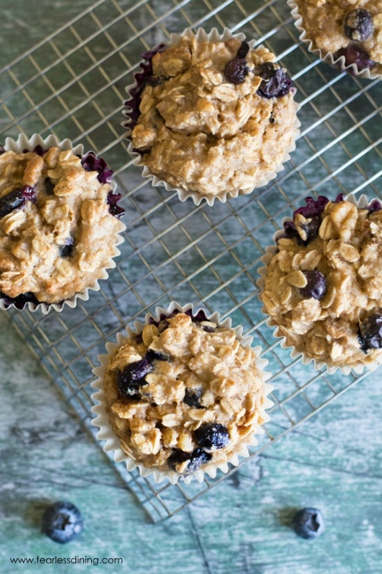 The top view of a rack of gluten free blueberry oat muffins