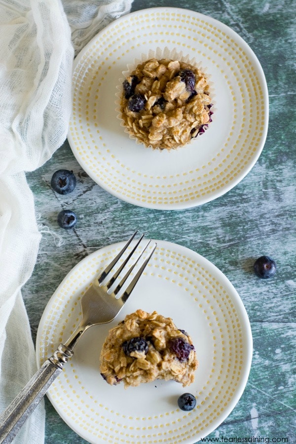 Top view of blueberry oatmeal muffins on two plates.