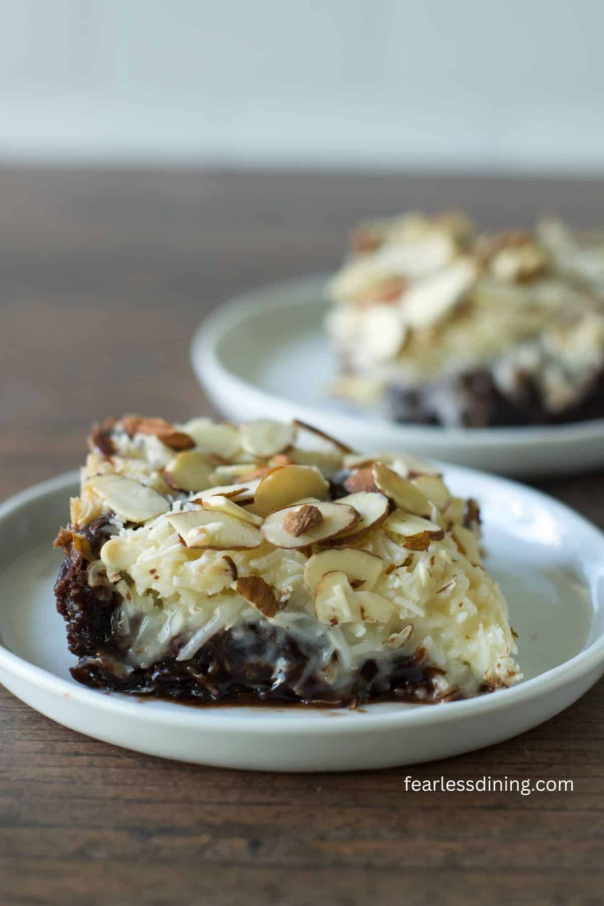 A slice of almond joy bar on a small white plate.