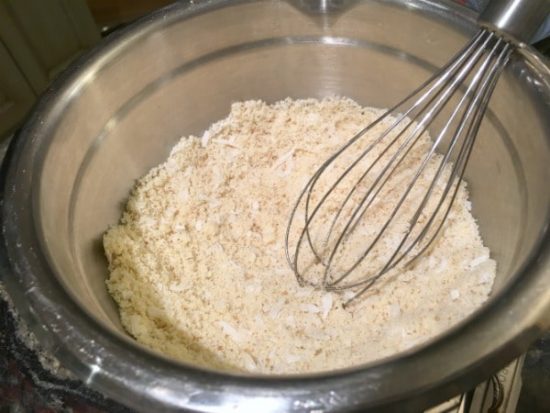 Tart crust ingredients being whisked in a bowl