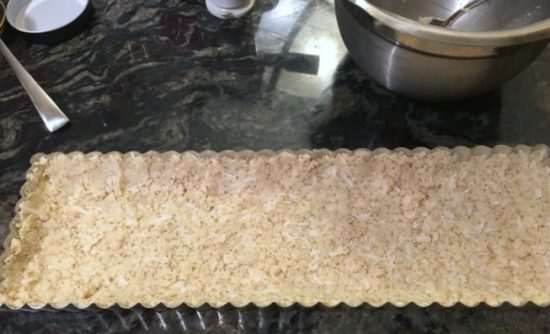 The tart crust in the rectangular tart pan.