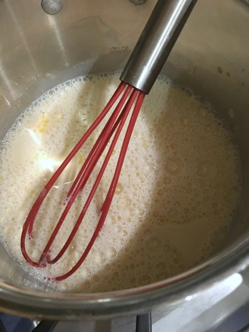 Apple custard wet ingredients being whisked in a bowl