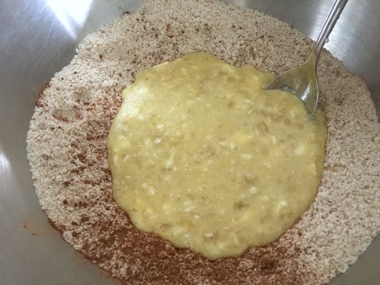 Banana donuts wet and dry ingredients in a bowl.