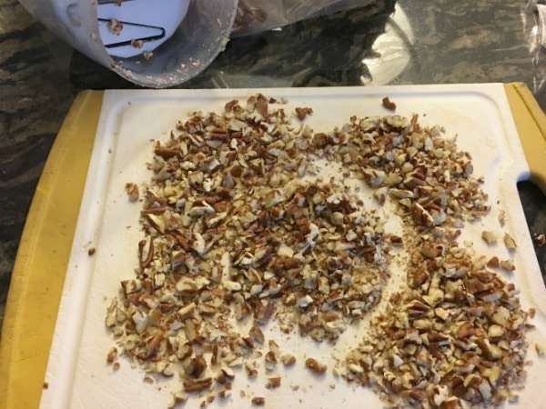 Chopped pecans on a cutting board.