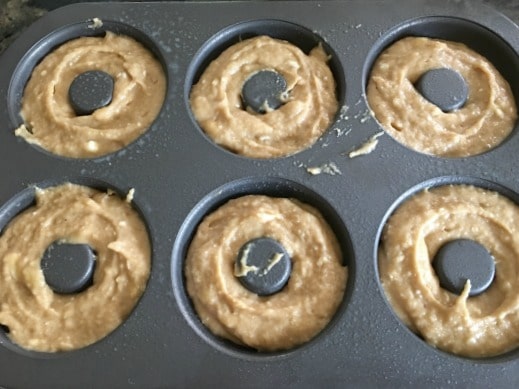gluten free banana batter in a donut pan ready to bake.