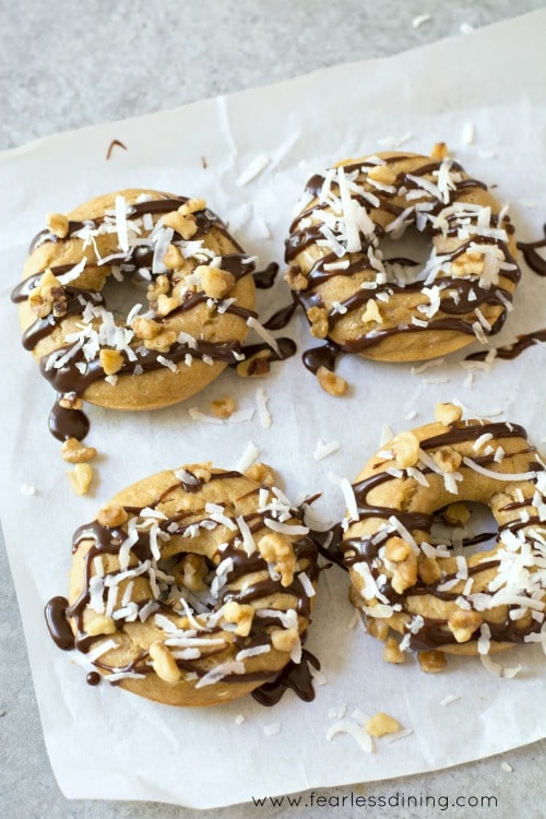 Top view of Gluten Free Banana Donuts with Chocolate Coconut Walnuts on top