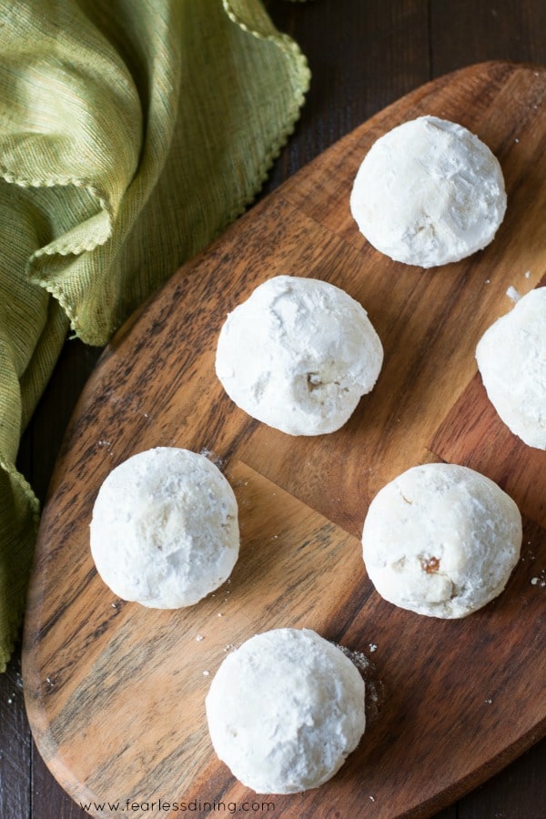 The top view of six tea cookies on a wooden serving board.