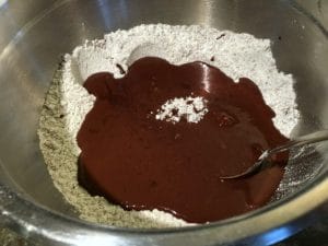 Adding the wet and dry ingredients in a bowl.