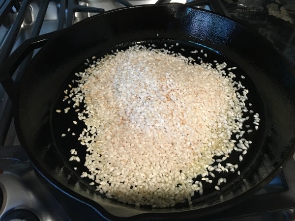 Heating the rice and oil in a cast iron skillet.