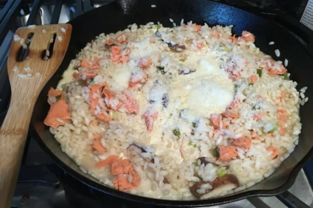 Adding the smoked salmon to the risotto.