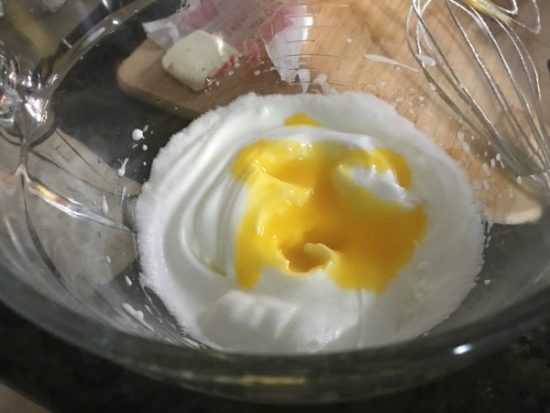 Egg whites and egg yolks in a bowl.