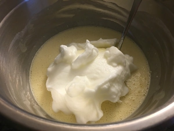 Mixing up the lemon cake batter in a large bowl.