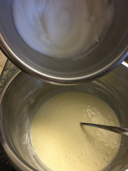 Adding meringue to cake batter.