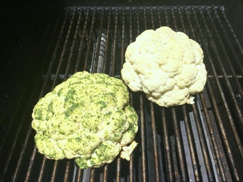 Two heads of cauliflower on the grill.