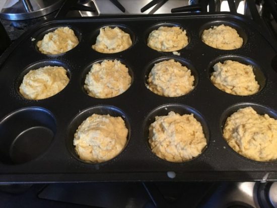 Corn bread batter in a muffin tin ready to bake.