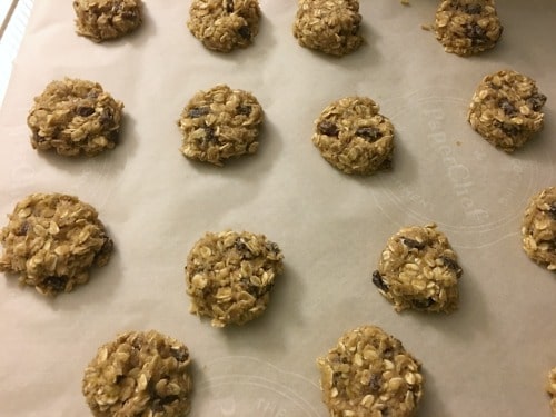 Gluten free oatmeal cookie dough balls on cookie sheet.