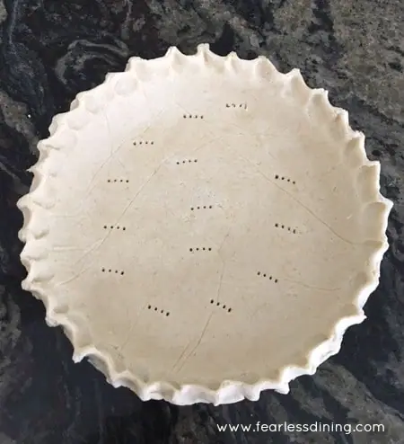 Gluten Free Pie Crust with fork holes poked into it, ready for baking