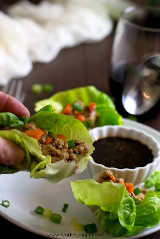 A hand holding an Asian Lettuce Wrap.