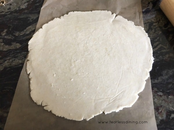 a flattened pie crust after rolling it out on wax paper.