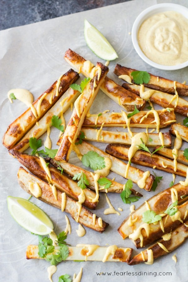 French fries with a curry sauce and cilantro drizzed over the top.