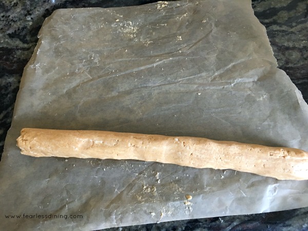 Rolling the peanut butter candy dough into a rod.