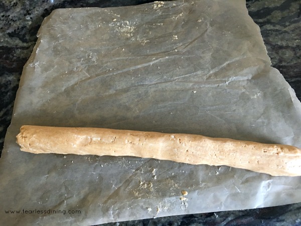 Rolling the peanut butter candy into a log.
