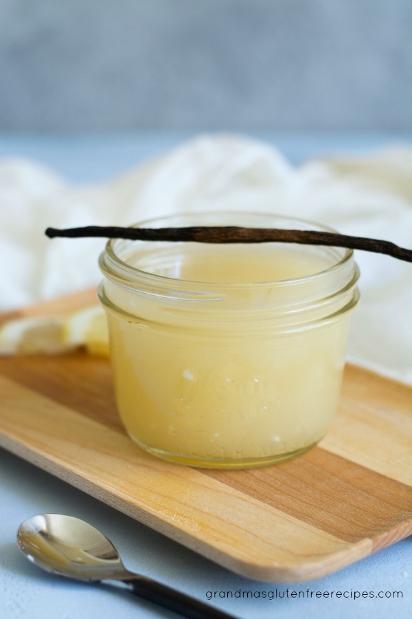 Quick and easy vanilla cream sauce with a vanilla bean on top of the jar.