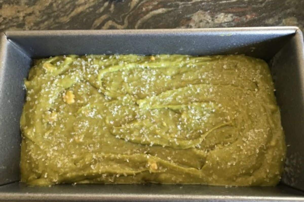 The matcha bread batter in a loaf pan ready to bake.