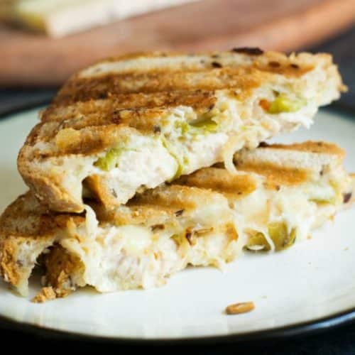 Two halves of a tuna panini stacked on top of each other.