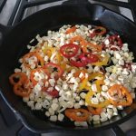Cooking vegetables in a cast iron skillet.