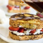 Pouring syrup over the gluten free stuffed French toast.