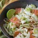 A large bowl filled with pink grapefruit and fennel salad.