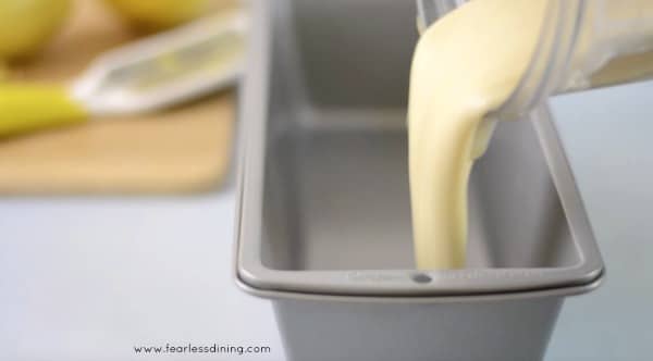 Pouring the no-churn ice cream mix into a bread tin.