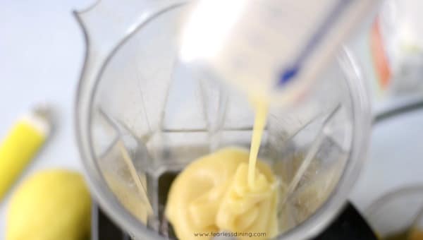 A photo showing adding the condensed milk to the Vitamix.