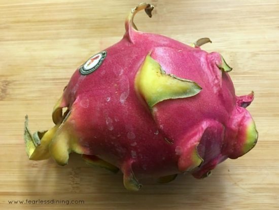 Dragon fruit sitting on a cutting board.