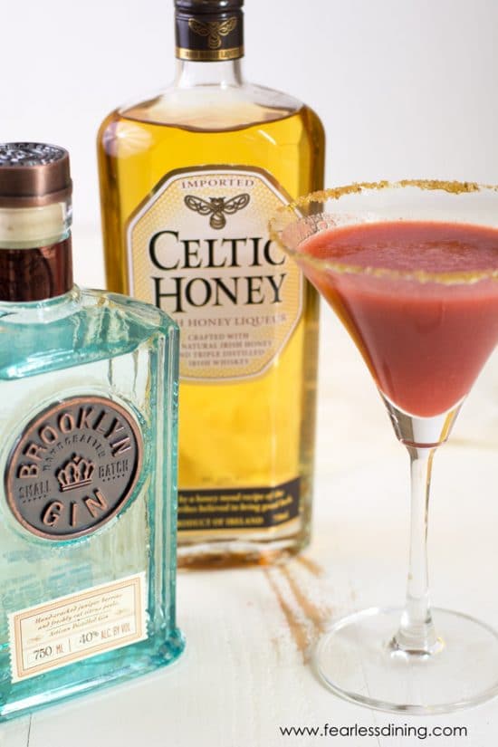 Bottles of Brooklyn Gin and Celtic Honey Liquor next to a martini glass.