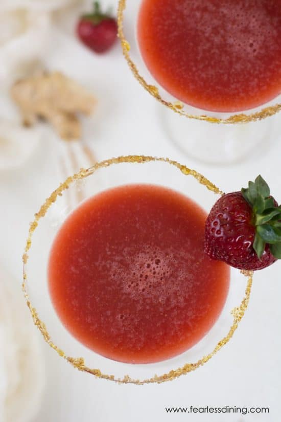 Top view of honey gin strawberry ginger cocktails with a ginger sugar rim