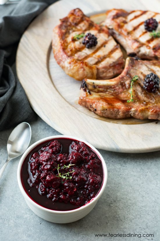 A plate of grilled pork chops and olallieberry sauce.