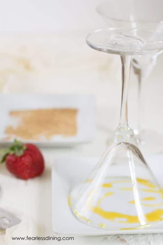 Dipping the rim of the martini glass in honey.